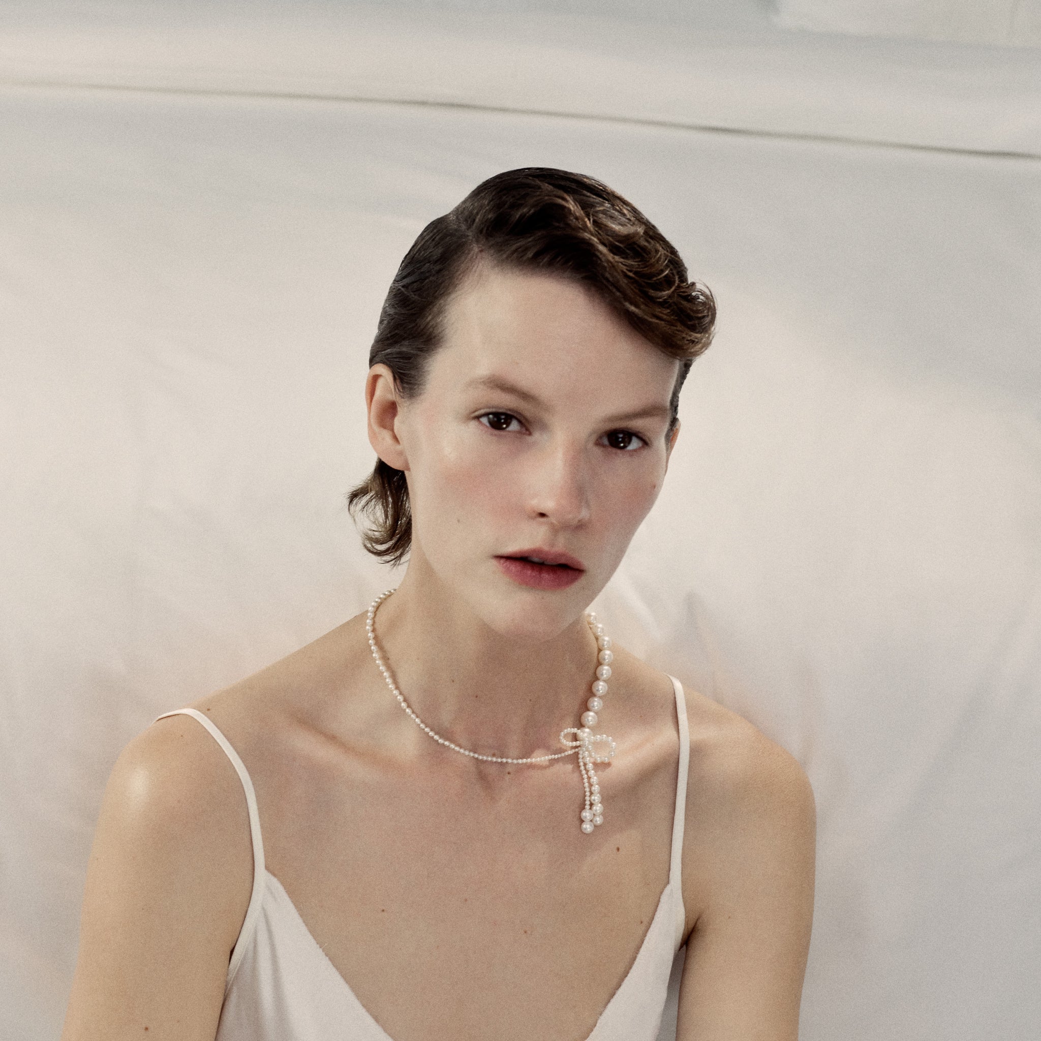 Model wearing Peggy Rosette necklace from the Autumn & Winter 2022 collection; The Bow.