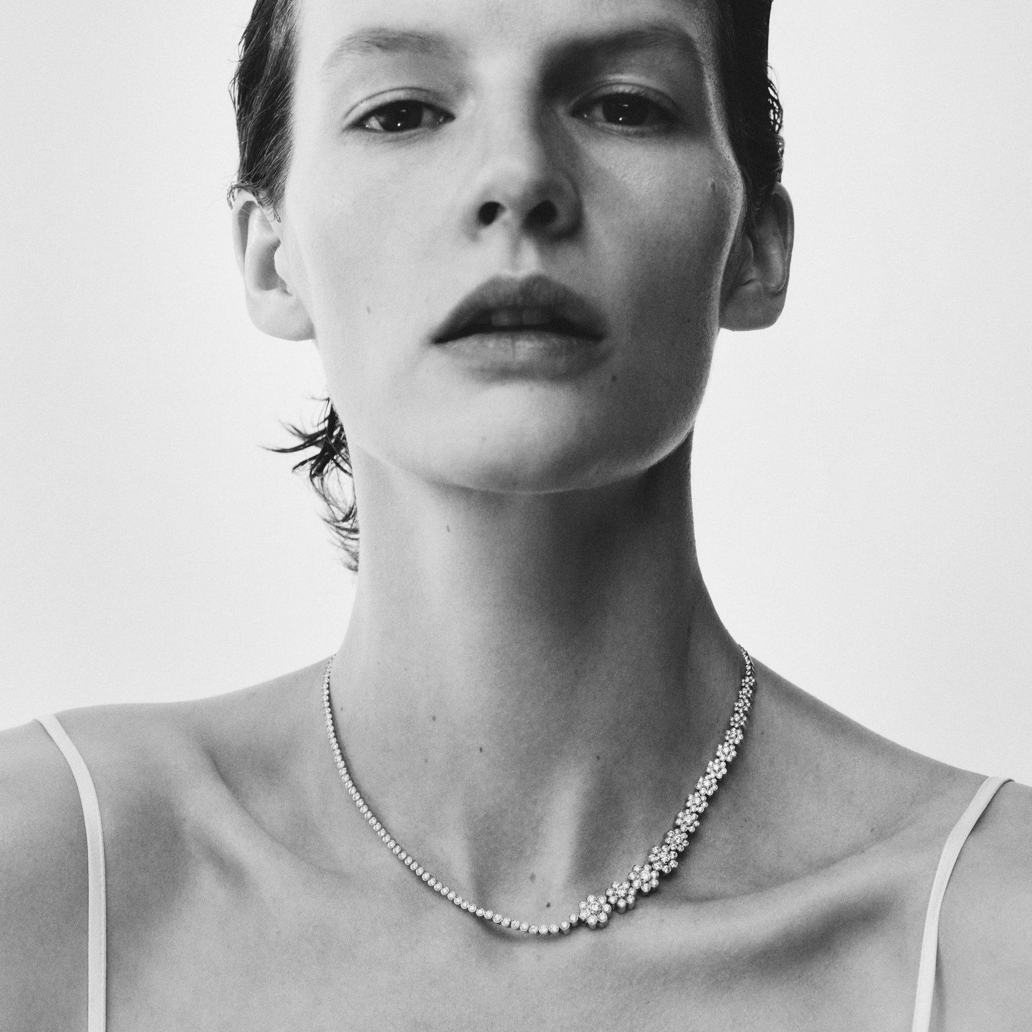 Model wearing Fleur de Tennis necklace. Crafted in 18K yellow gold with Top Wesselton VVS diamonds. 