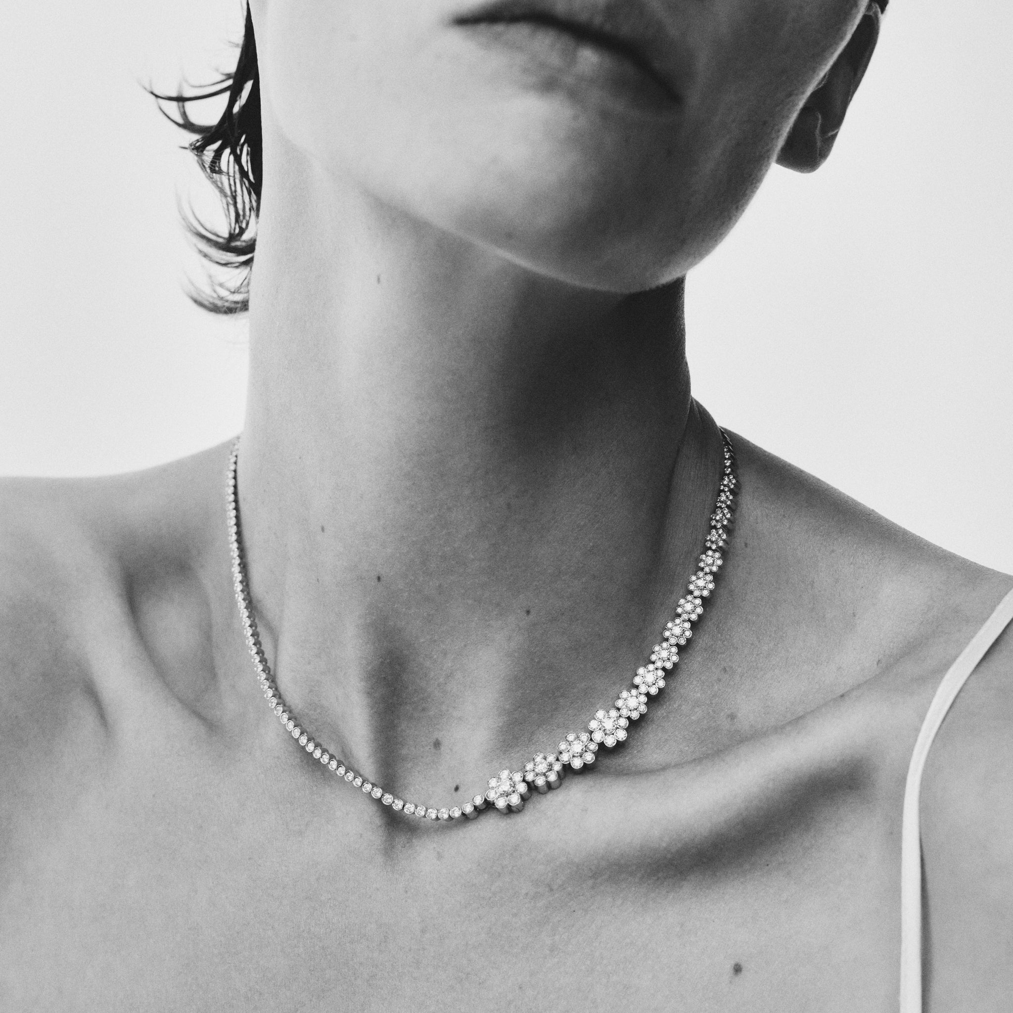 Model wearing Fleur de Tennis necklace. Crafted in 18K yellow gold with Top Wesselton VVS diamonds. 