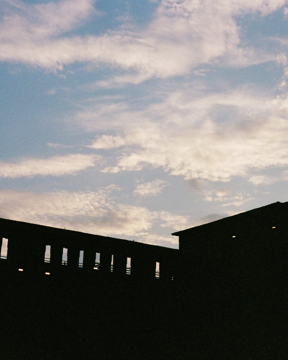Silhouette of a building against clouds in the sky