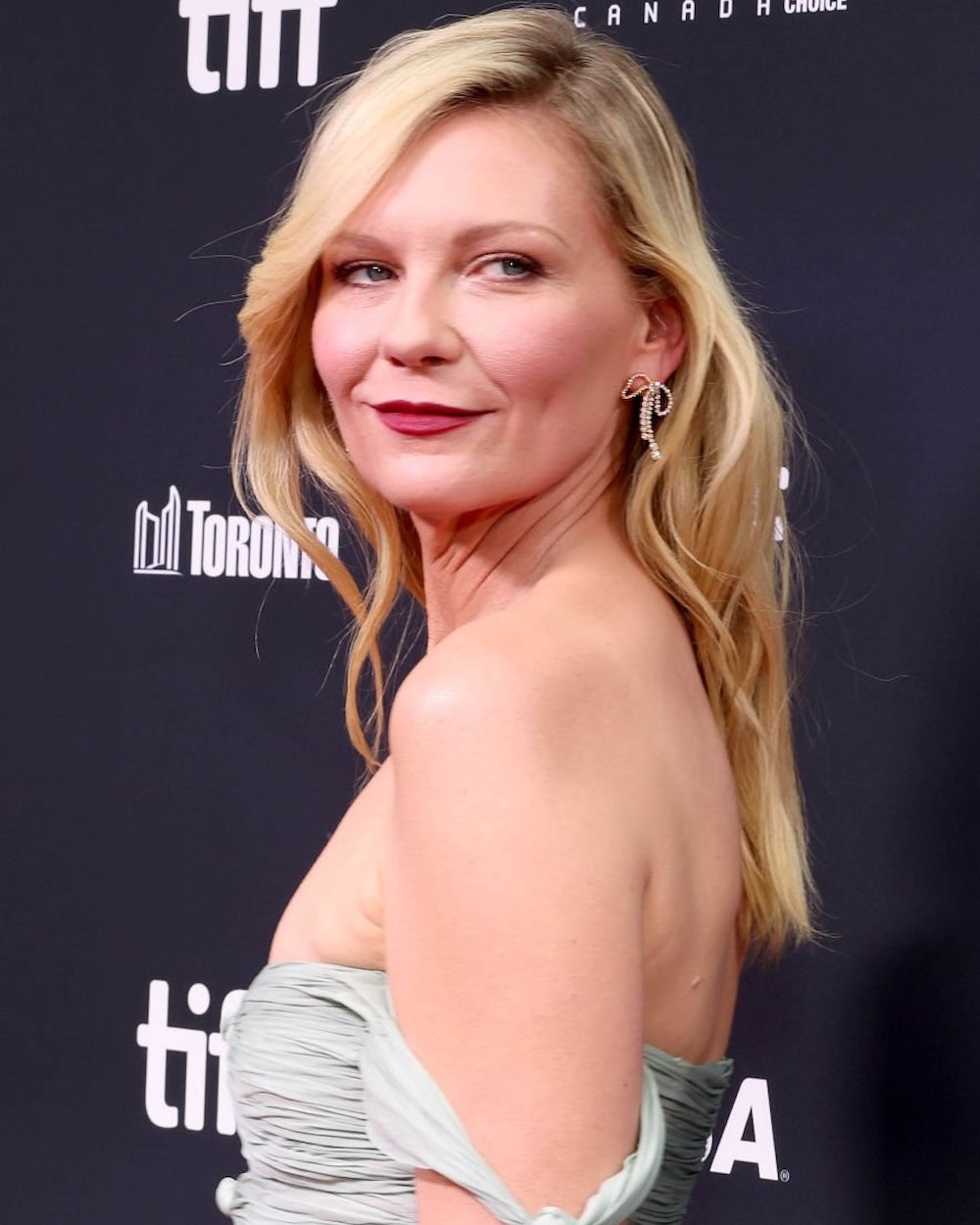 Actress Kirsten Dunst wearing Rosette earrings.