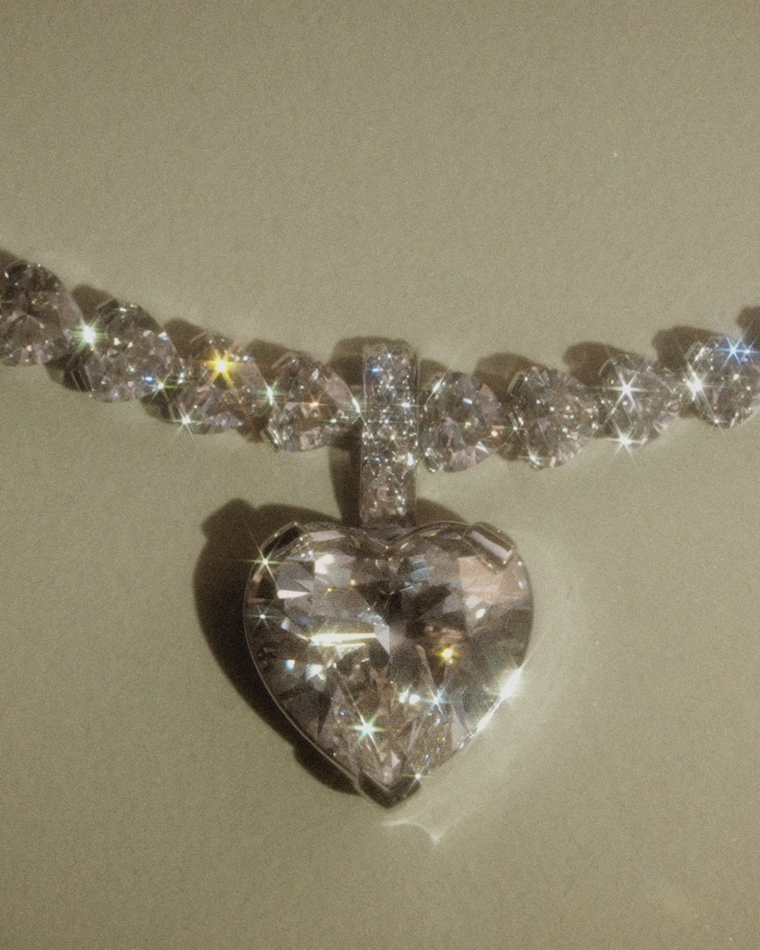 Sky 4 diamond necklace with heart shaped diamonds with pendant on a beige background