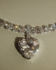 Sky 4 diamond necklace with heart shaped diamonds with pendant on a beige background