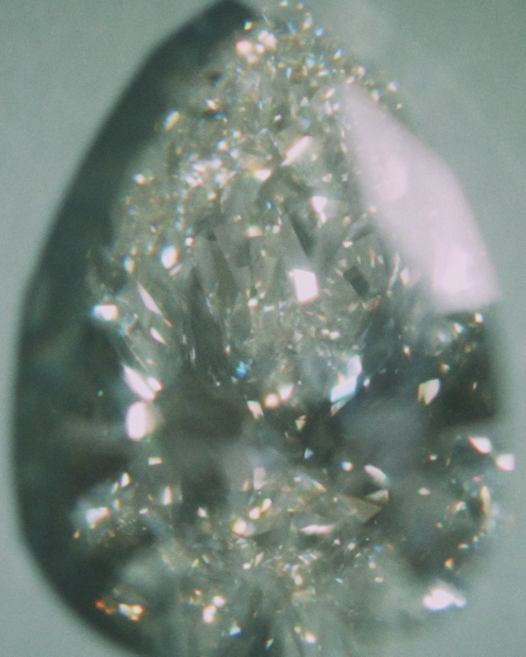 Pear shaped diamond on a light gray backgroun