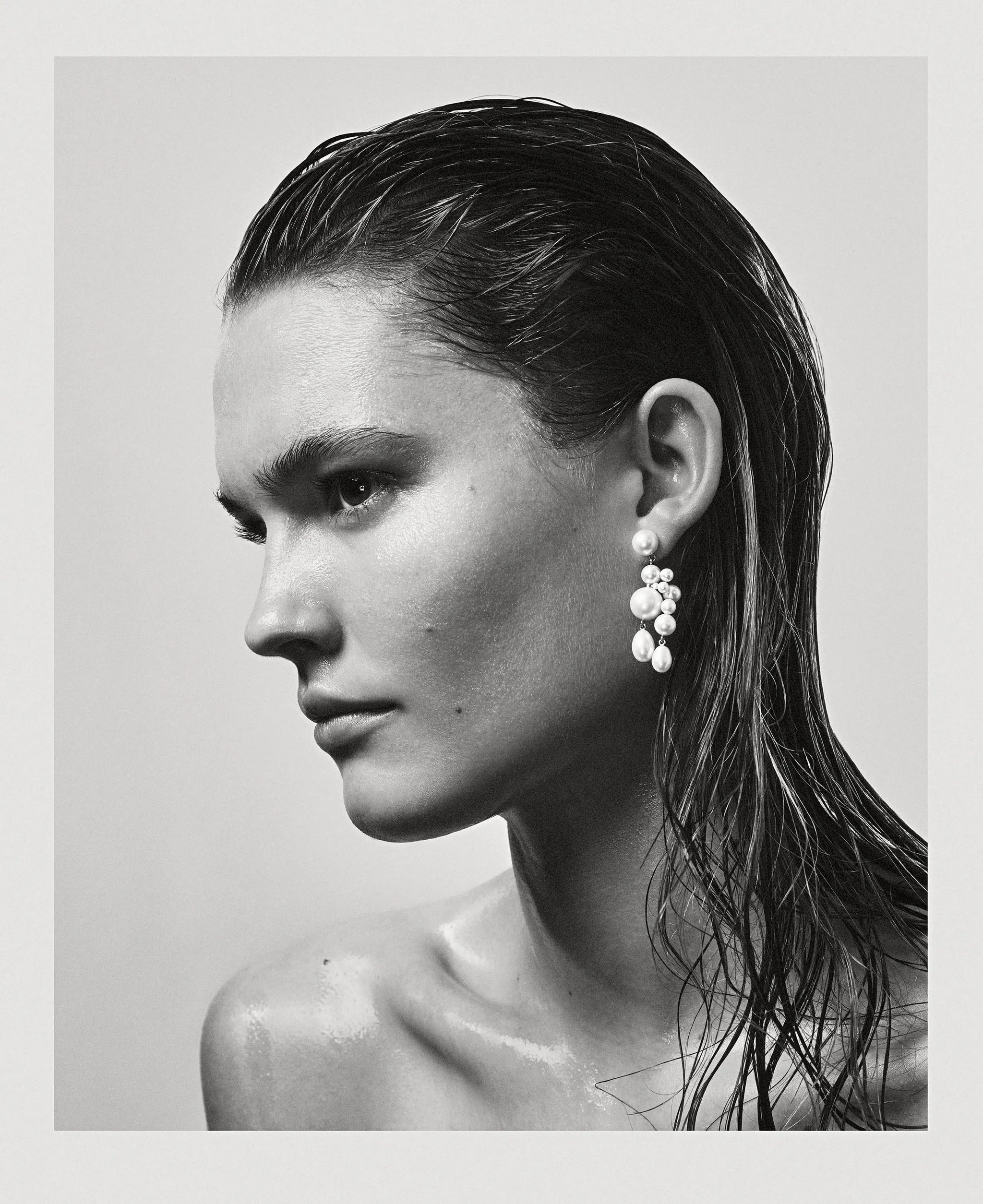 Black and white photography of model wearing Beverly pearl earrings